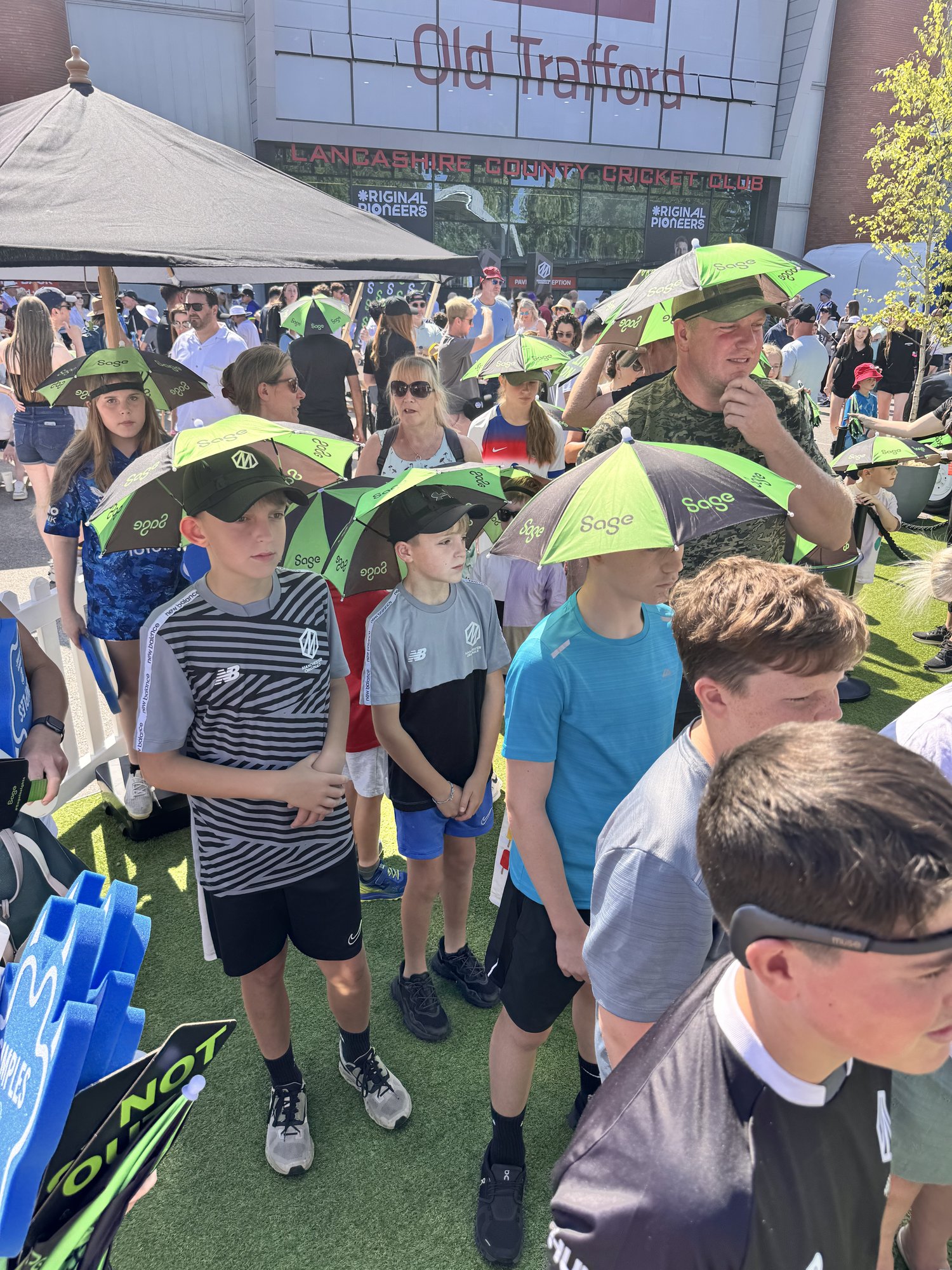 Crowd of children in Sage bucket hats at The Hundred, Old Trafford